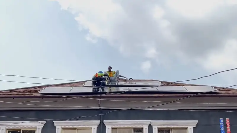 The crew fitting panels along the supermarket roof.