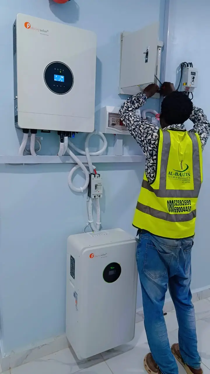 A technician wiring the inverter into the distribution board.