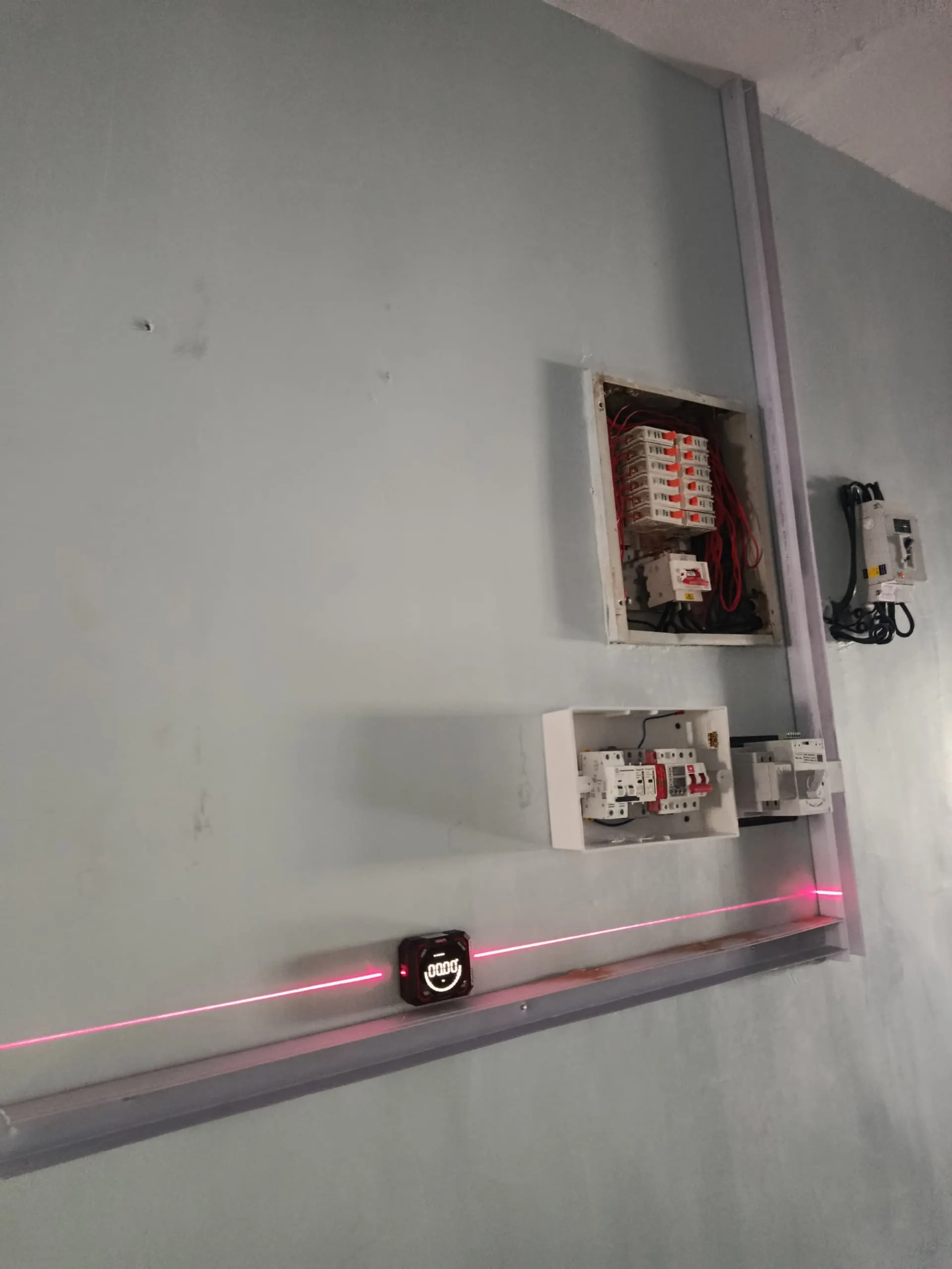 The finished distribution board with its conduit run neatly along the wall.