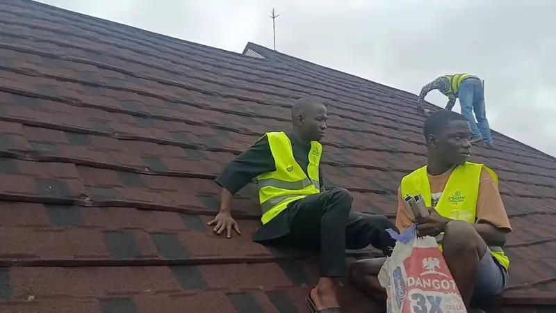 The crew working along the panel rails on the hotel roof.