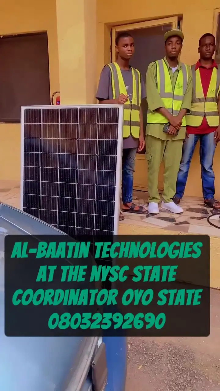 Al-Baatin fitters in hi-vis vests preparing solar panels, cabling and inverter equipment at the NYSC State Coordinator's office.