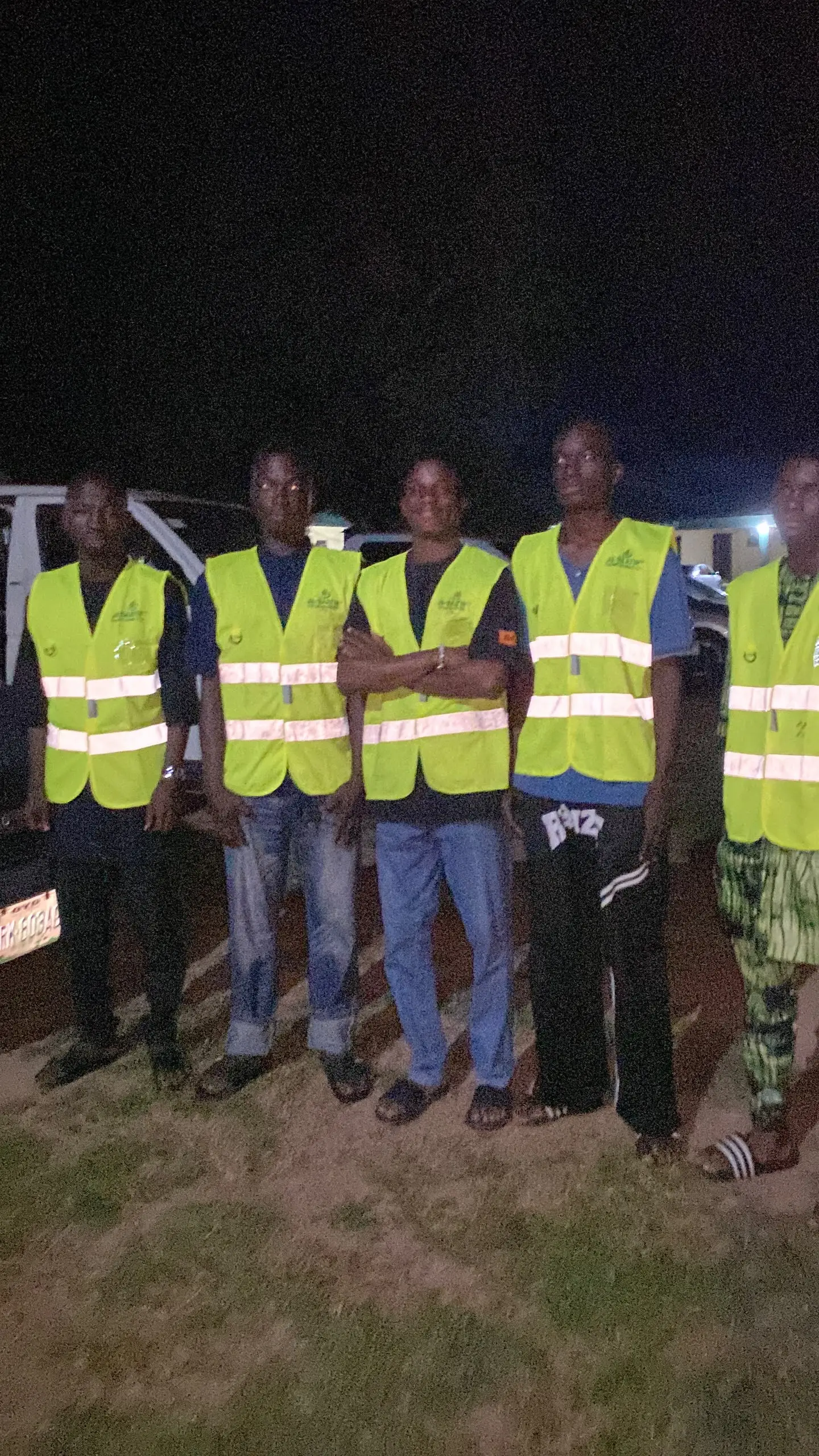 The crew lined up in branded hi-vis vests at the end of an evening job.