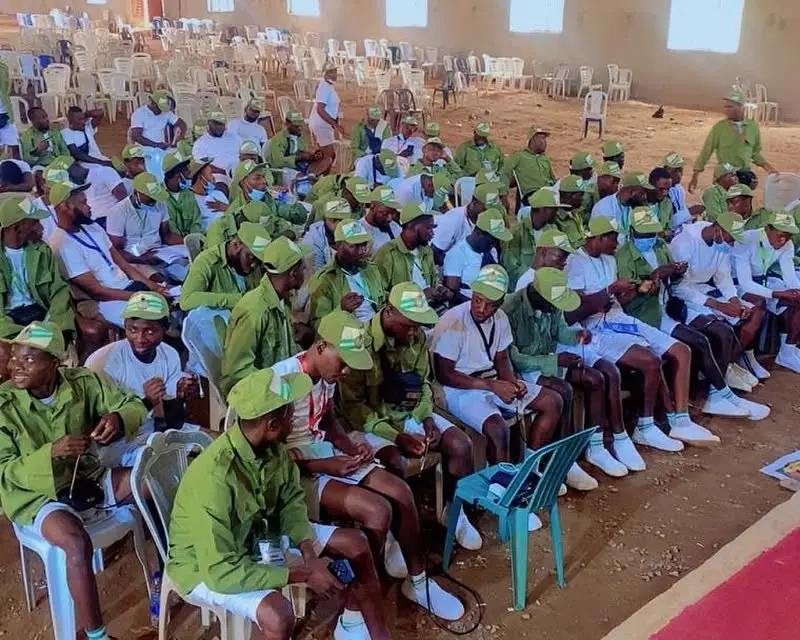 Corps members seated in the camp hall during a session.